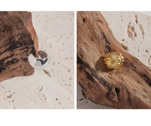 Detail showing polished silver and matte gold geometric earrings with textured finish