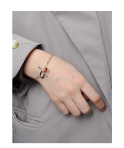 Macro detail of S925 sterling silver toggle clasp bracelet with orange zircon gemstone