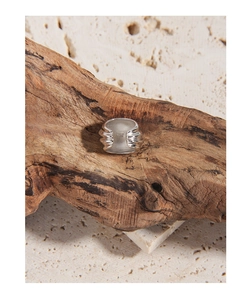 Macro shot of 925 sterling silver stamp on minimalist wave textured ring band