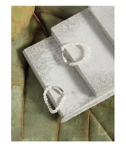 Detail of S925 sterling silver stamp on minimalist freshwater pearl beaded rings