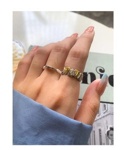 Detail of S925 silver heart shaped bicolor ring and pearl band set on model hand