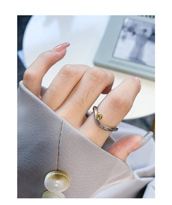 Close-up of S925 sterling silver two-tone geometric ring with a polished gold bead