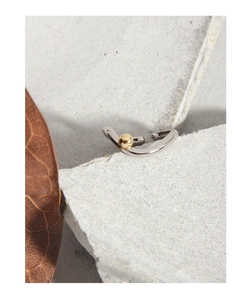 Macro view of S925 sterling silver geometric ring with a minimalist gold bead detail
