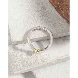 Minimalist S925 sterling silver open ring with a gold bead on a natural stone base