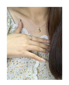 Polished gold heart pendant on silver snake chain with U-shaped crystal ring detail