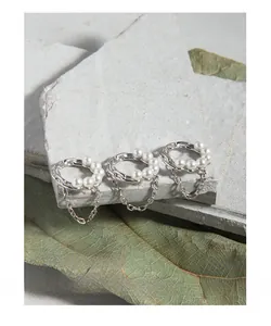 Detailed macro view of S925 sterling silver geometric rings set with white pearls