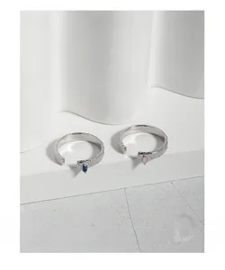 Detail of S925 silver textured rings with rectangular blue and pink zircon stones