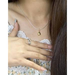 Silver S925 snake chain with gold heart pendant and horseshoe ring on lace top