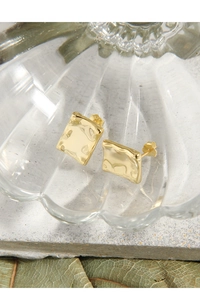 Macro shot of gold square stud earrings with irregular hammered texture on S925 silver