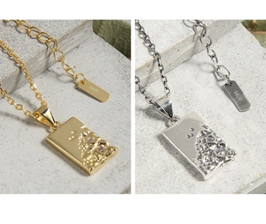 Detailed close-up of lava texture pendants in silver and gold with S925 engraving