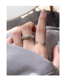 Macro shot of S925 silver rings with micro-set pink zircons and textured band on hand