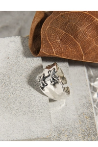 Macro detail of S925 sterling silver ring with unique stitched band and hammered texture