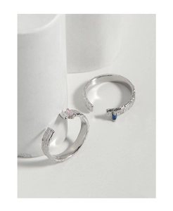 Detail shot of textured silver rings featuring micro-set blue and pink zircon stones