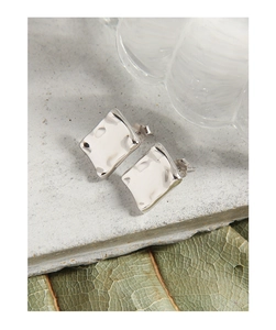 Detail view of silver S925 geometric irregular square earrings on stone
