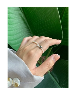 Close-up of S925 silver heart and natural white pearl beaded ring on model finger