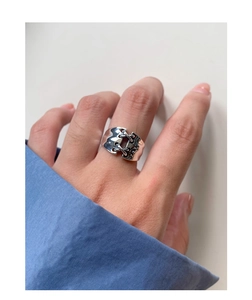 Detail of vintage S925 silver wide ring with a unique lace-up corset design on finger