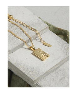 Macro shot of S925 sterling silver gold rectangular pendant with micro-set zircon details