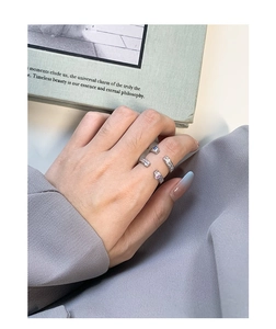 Detail view of S925 silver rings set with blue and pink cubic zirconia on a hand