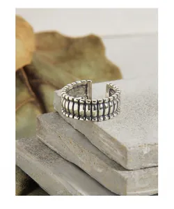 Macro detail of vintage S925 silver ring featuring vertical stripes and open adjustable band
