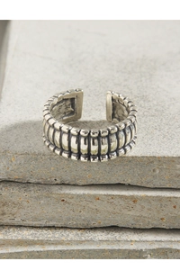 Macro detail of retro S925 sterling silver ring with textured grid pattern design