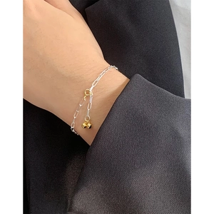 Minimalist S925 sterling silver paperclip bracelet with two-tone gold beads on female wrist
