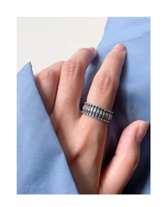 Macro shot of vintage S925 silver wide band ring with vertical grid texture on a hand