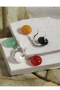 Detailed macro view of S925 silver hoop earrings with diverse natural jade pendants