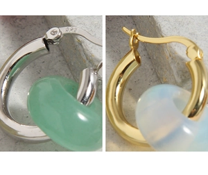 Detailed close-up of S925 silver earrings with jade pendants and 925 hallmarks