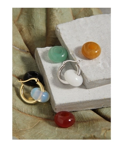 Macro shot of S925 sterling silver hoop earrings with interchangeable colorful jade beads
