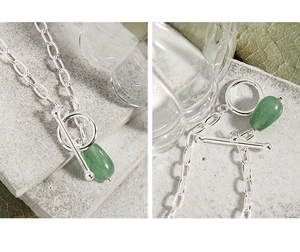 Close-up of S925 silver necklace with green teardrop pendant and elegant OT buckle