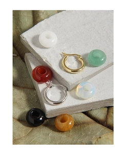 Macro shot of S925 silver hoop earrings with interchangeable colorful gemstone beads