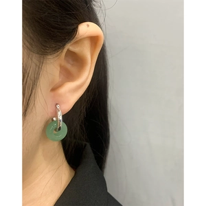 Minimalist S925 silver hoop earrings featuring green jadeite donut pendant on model