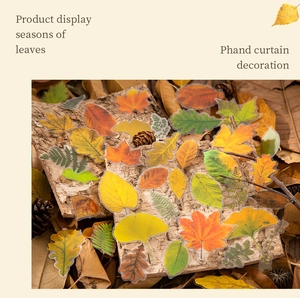 Macro detail of autumn leaf stickers featuring maple and ginkgo designs for DIY journals
