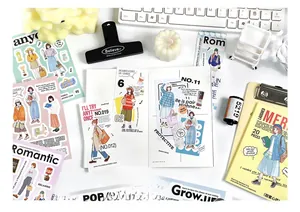 Flat lay of vintage style human figure stickers and inspiring quotes for DIY journals