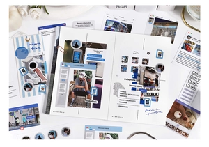 Detail view of retro computer UI style stationery with stickers and blue striped notebook