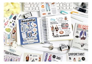 Detail of fashion illustration stickers and notebook DIY materials in a stylish setup