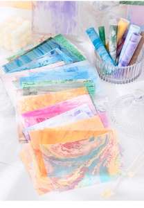 Detailed view of colorful translucent vellum paper with fluid marble textures for journaling