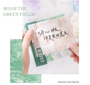 Detail view of retro green texture paper for scrapbooking with metal paper clip