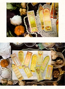 Close-up of vintage baroque stained glass bookmarks with gold foil and floral details