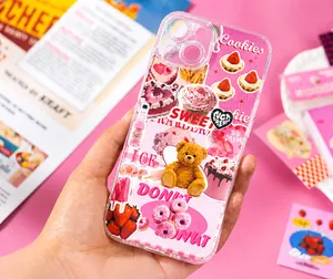 Detail of pink strawberry and teddy bear stickers decorating a clear phone case