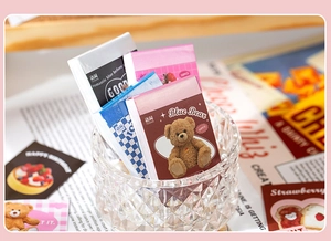 Detail of 50-sheet mini sticker pads featuring teddy bear and strawberry patterns