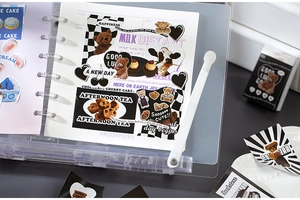 Detail of Teddy bear and afternoon tea stickers on a transparent binder DIY page