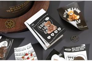 Close-up of 50 vintage teddy bear and dessert stickers for journal decoration