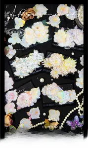 Macro shot of floral PET stickers with laser gold foil edges on a vintage black background