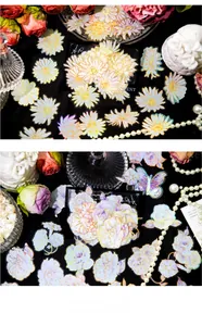 Macro detail of holographic floral PET stickers featuring daisy and rose with gold foil edges