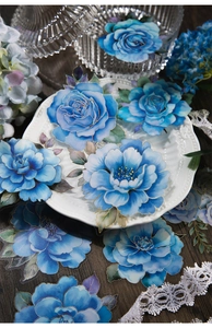 Detailed blue floral PET stickers with gold foil accents on a vintage ceramic plate