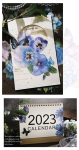 Detailed view of floral stationery kit featuring blue pansy stickers and a 2023 calendar