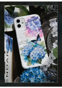 Artistic close-up of blue hydrangea and butterfly floral pattern on white phone case