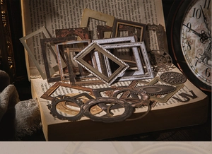 Close-up of vintage hollow frame cutouts on aged book pages for DIY scrapbooking
