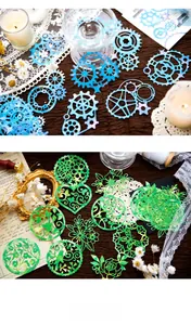Detailed view of hollow gold foil paper stickers with watercolor gradients for journaling